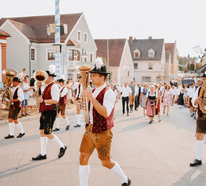Kapelle marschiert auf einer Hauptstraße bei einem Festumzug durch eine Stadt
